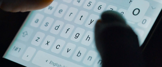 Two fingers typing on a smart phone keyboard